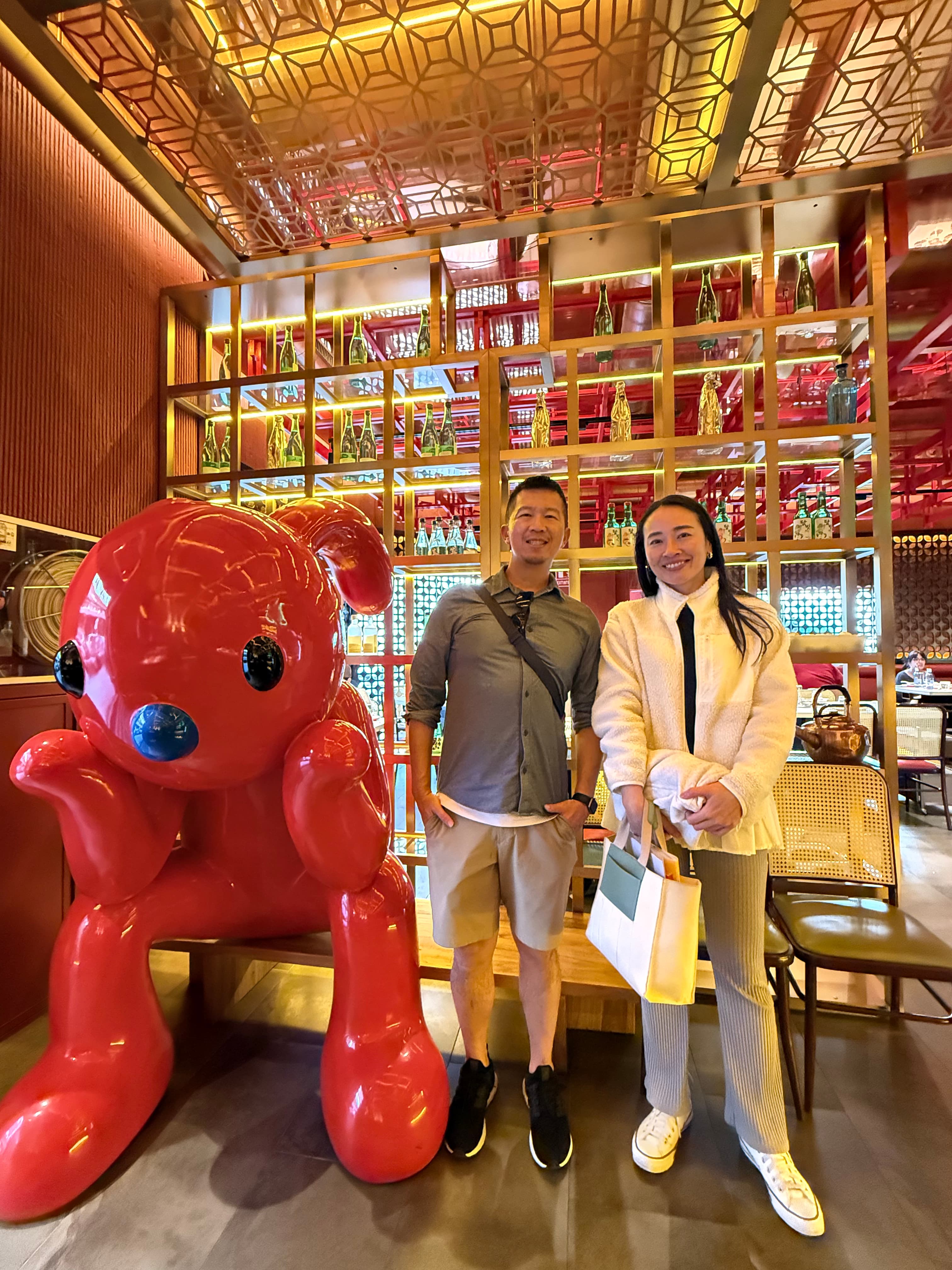 Posing with the red bear sculpture at Sukijoy entrance